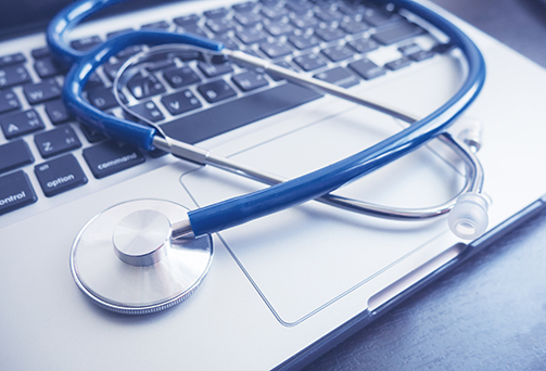 Stethoscope on laptop keyboard, Healthcare and Medical concept, selective focus, vintage color. morning light